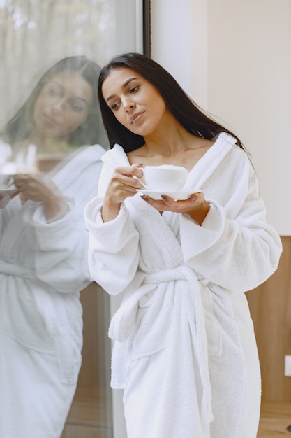 Buongiorno. La donna beve il caffè. Signora alla finestra.