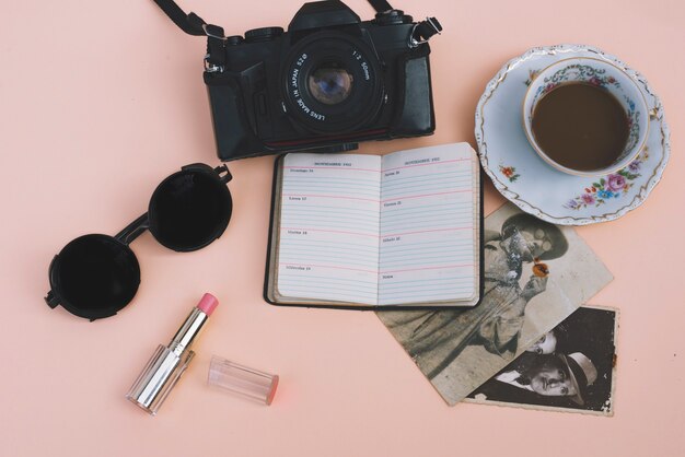 Caffè e macchina fotografica vicino ad accessori preziosi