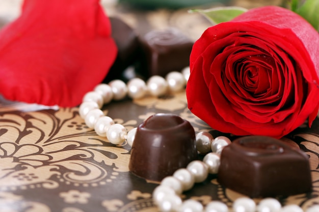 Caramelle al cioccolato e rose rosse