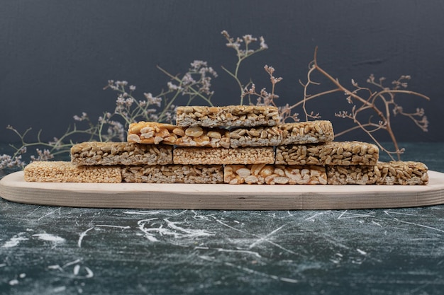 Caramelle fragili con piatto di legno di semi.