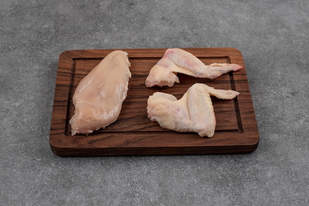Carni di pollo fresche biologiche. Carni crude su tavola di legno.
