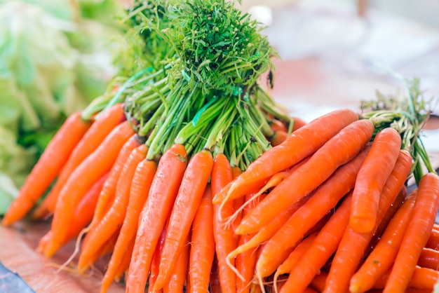 Carote. Carote organiche fresche. Carote di giardino fresco. Mazzo di carote organiche fresche al mercato.