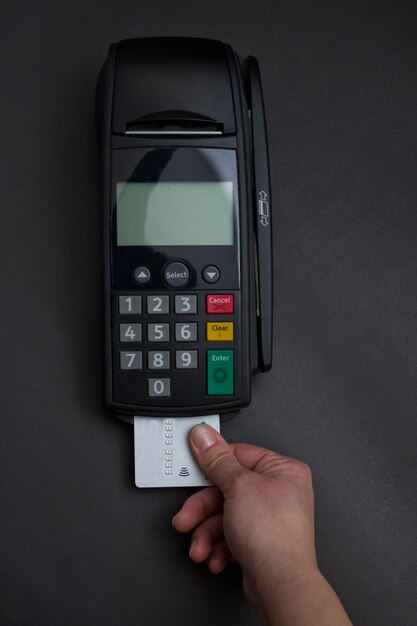 Carta di credito di spostamento della mano nel deposito. Mani femminili con carta di credito e bancomat. Immagine a colori di un POS e carte di credito.