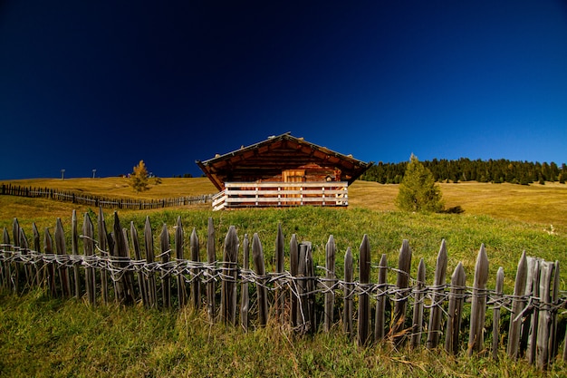 Casa in un campo erboso con staccionata in legno in dolomia Italia