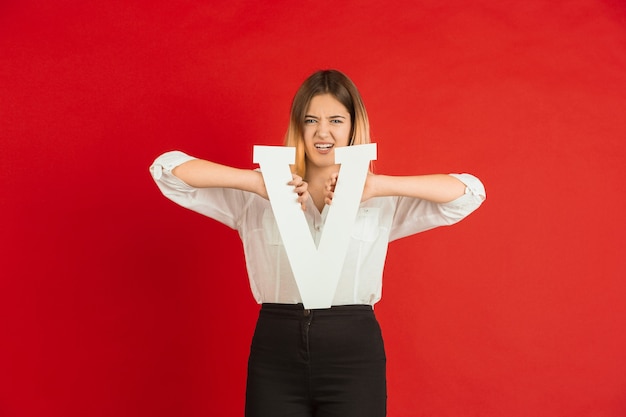 Celebrazione di San Valentino, felice ragazza caucasica tenendo la lettera su sfondo rosso