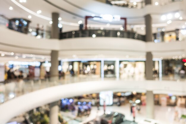 Centro commerciale astratto della sfuocatura e interno del negozio di vendite per fondo