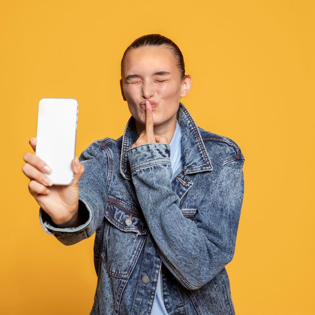 Cheeky woman holding smartphone