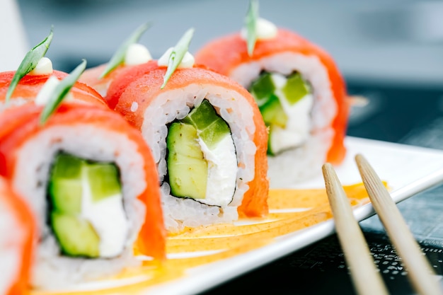 Chiuda in su dei rotoli di sushi del tonno con l'avocado