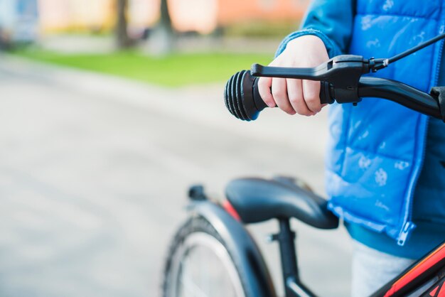 Chiuda in su del bambino con la bici all&#39;esterno