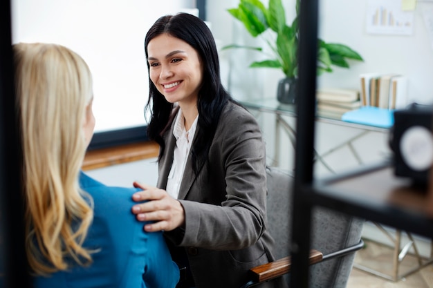 Chiuda in su persone sorridenti che lavorano insieme