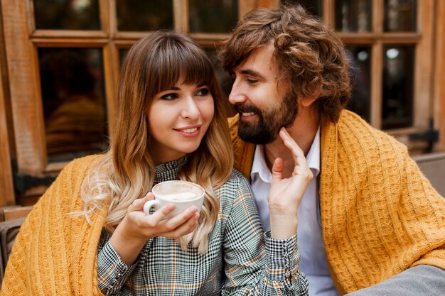 Chiuda sul ritratto caldo accogliente delle coppie che abbracciano felici nell'amore.