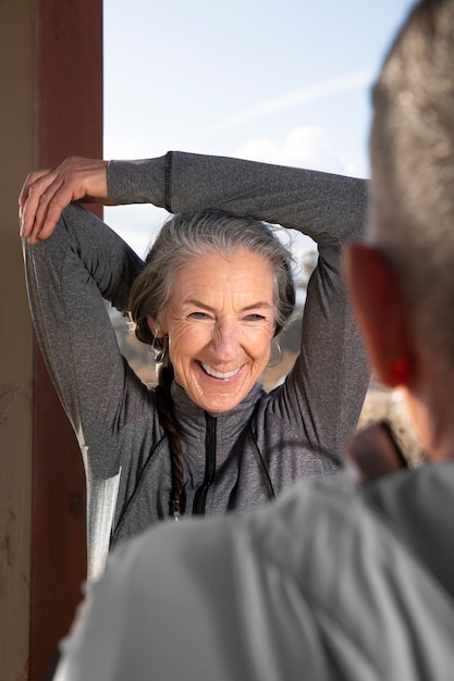 Chiuda sulla donna che si estende all'aperto