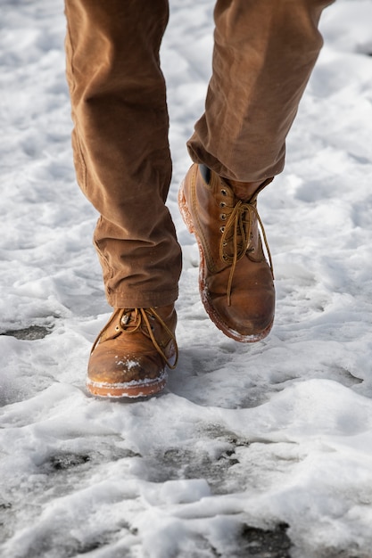 Chiuda sulle gambe che camminano nella neve