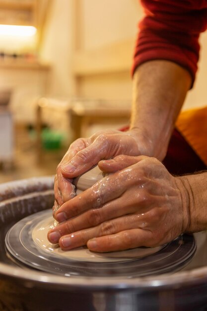 Chiudere le mani facendo ceramiche