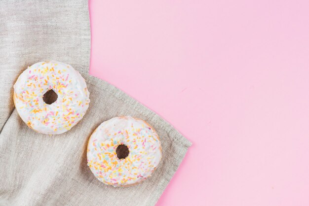 Ciambelle al cioccolato bianco su stoffa grigia