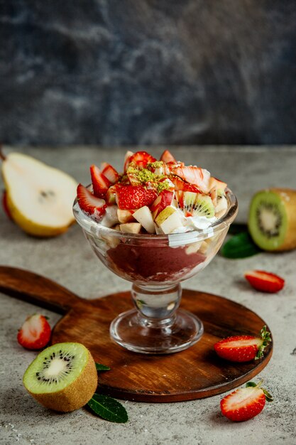 Ciotola di frutta con mousse al cioccolato e panna