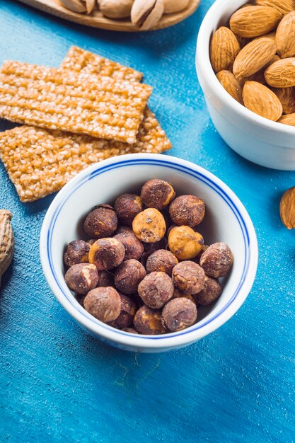 Ciotola di nocciole tostate e mandorle con barrette proteiche