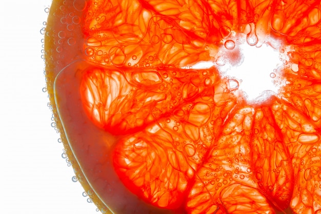Close-up di fetta di pompelmo con bolle ait su fibre succose