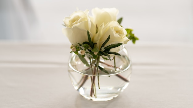 Closeup colpo di bouquet di rose bianche nella ciotola di vetro isolato