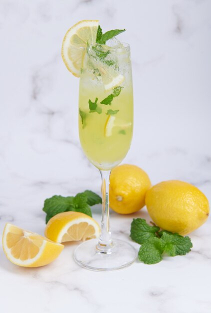 Cocktail estivo fresco con limoni, menta e ghiaccio, immagine di messa a fuoco selettiva, Mojito in una tazza di vetro, Limonata di agrumi freschi con lime e limoni. Bevanda fresca e fresca per il concetto estivo.