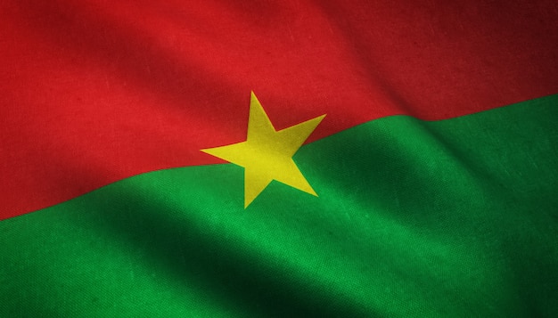 Colpo del primo piano della bandiera del Burkina Faso con strutture grungy