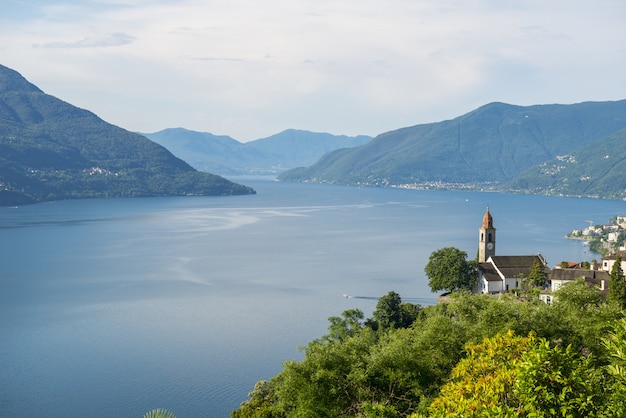 Colpo grandangolare di un lago circondato da alberi e montagne