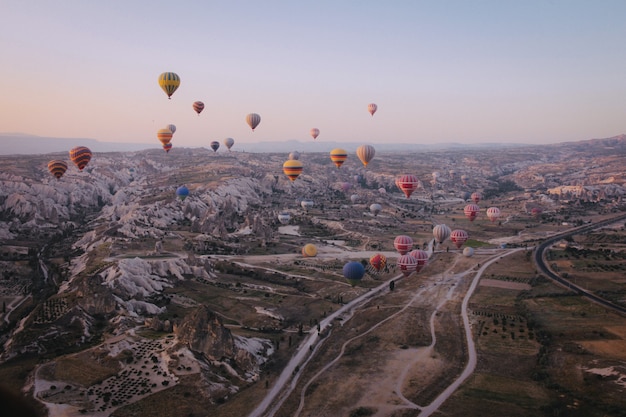 Colpo lungo di varie mongolfiere colorate multi che galleggiano nel cielo