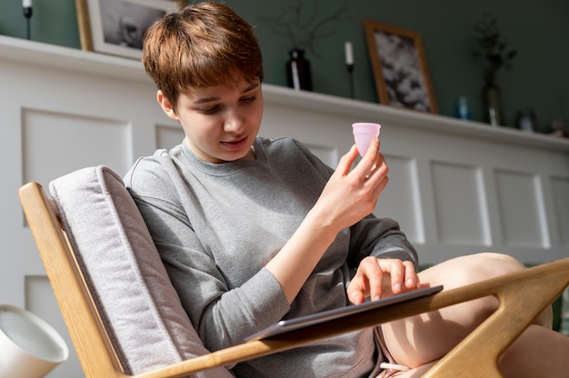 Colpo medio del prodotto mestruale riutilizzabile della donna che tiene