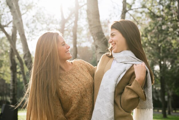 Colpo medio di due donne che parlano nel parco