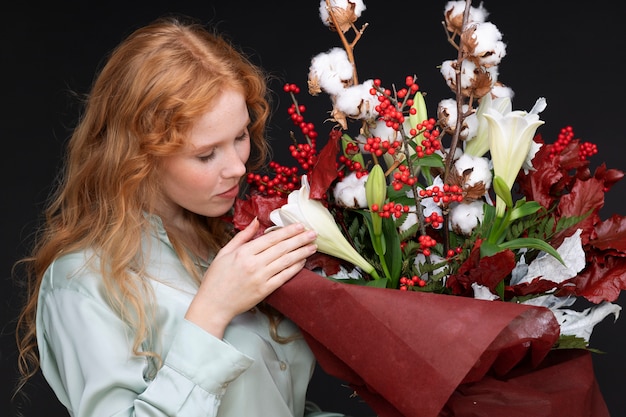 Colpo medio donna che odora di fiori