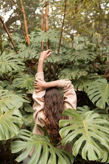 Colpo medio donna con pianta monstera