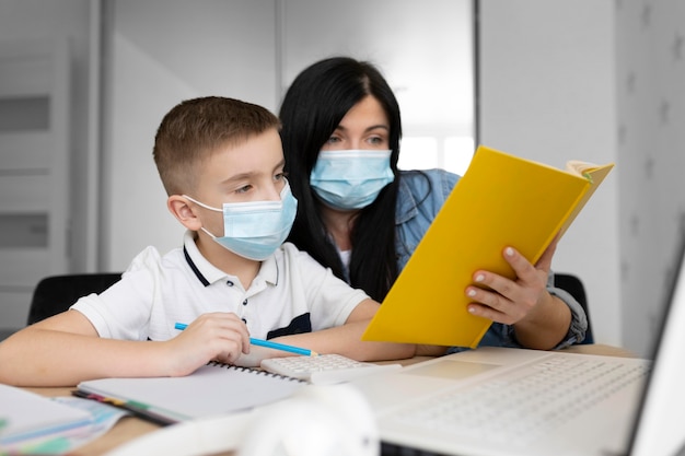 Colpo medio donna e bambino con maschera