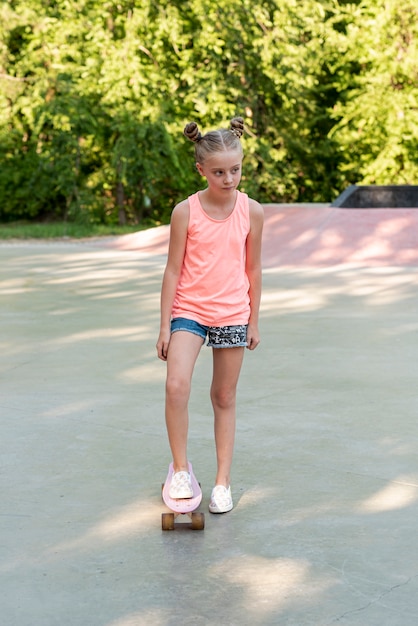 Colpo pieno di ragazza con skateboard