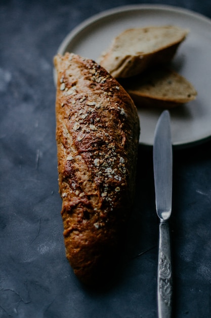 Colpo selettivo verticale del primo piano di un pane al forno su un piatto