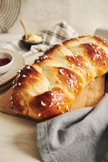 Colpo verticale di delizioso pane dolce di lievito su un tavolo bianco