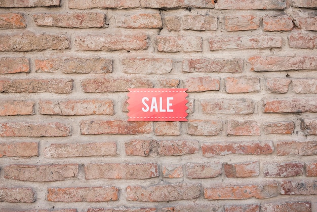 Compressa di vendita sul muro di mattoni
