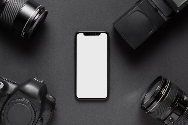 Concetto di fotografia con accessori per fotocamera e smartphone nel mezzo