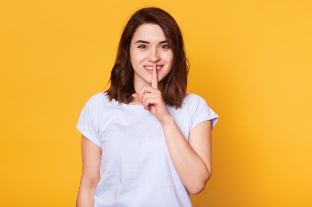 Concetto di linguaggio del corpo. Bella giovane femmina sorridente con espressione felice