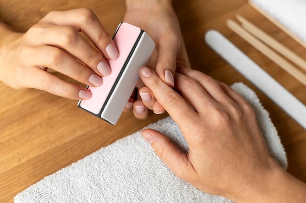 Concetto di manicure con lima per unghie