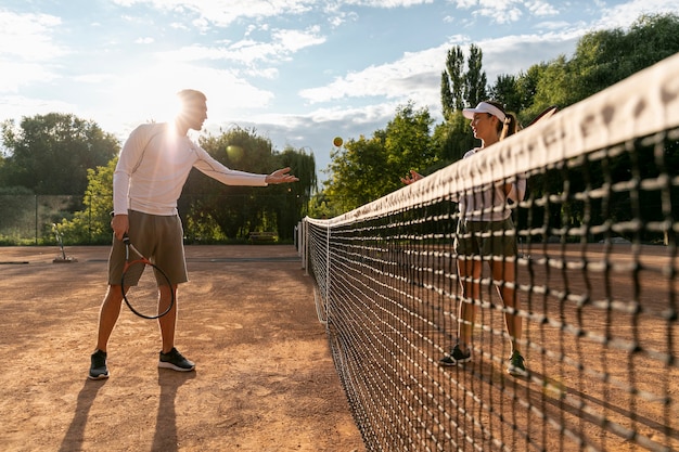 Coppia vista bassa giocando a tennis