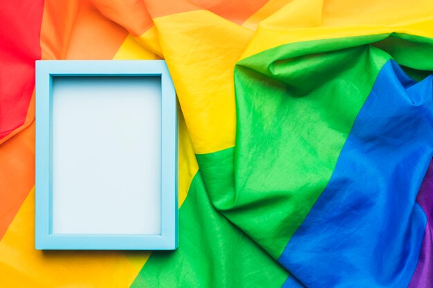 Cornice vuota blu su bandiera LGBT stropicciata