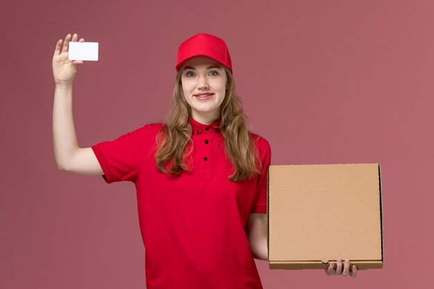 corriere femminile in uniforme rossa che tiene carta bianca e scatola di cibo sul lavoro di operaio di consegna servizio rosa, uniforme