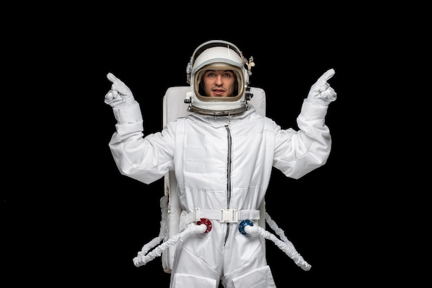 Cosmonauta di giorno dell'astronauta nel casco della tuta spaziale del cosmo dello spazio esterno che si presenta con le dita