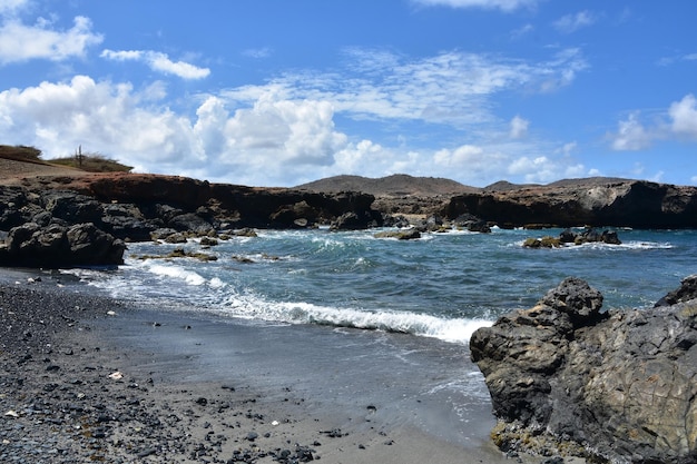 Costa frastagliata sulla spiaggia di pietra di sabbia nera