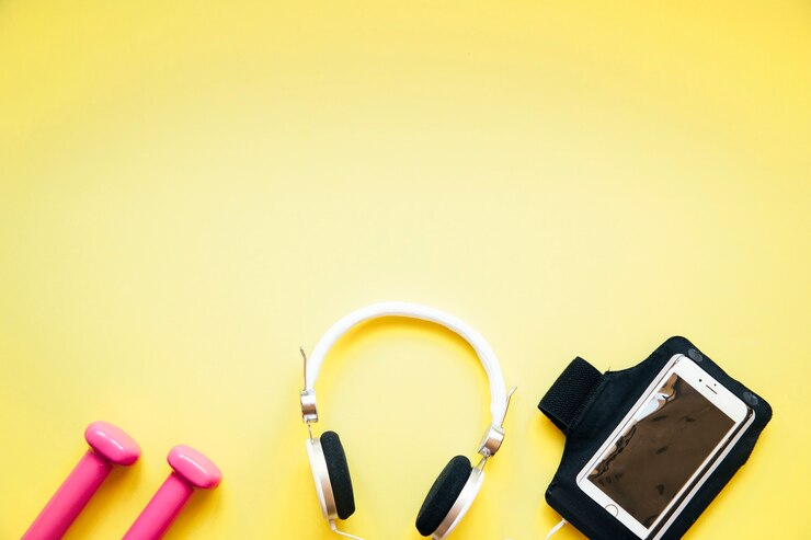 Foto gratuito cuffie tra smartphone e manubri