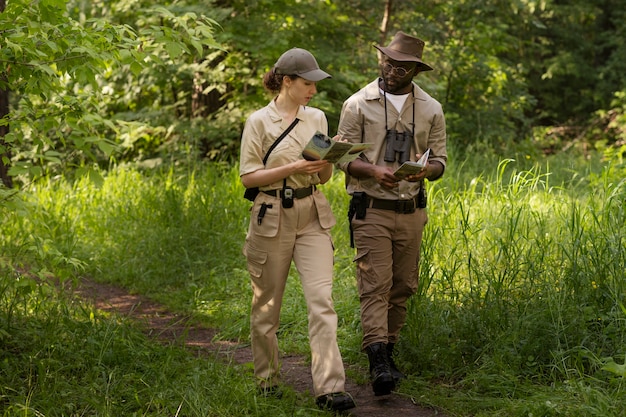 Custodi forestali a tutto campo che camminano nella natura