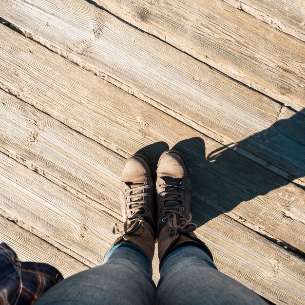 Da sopra le gambe sul pavimento di legno