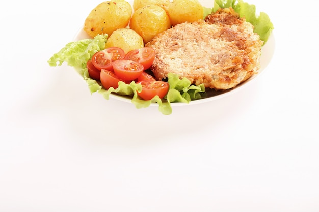 Deliziosa cena con bistecche, patate lesse e insalata