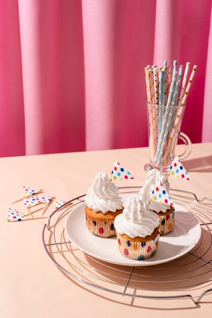 Disposizione della tavola per l'evento di compleanno con cupcakes e cannucce