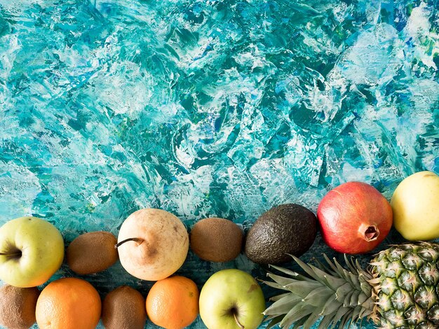 Diversi frutti freschi su sfondo di legno colorato